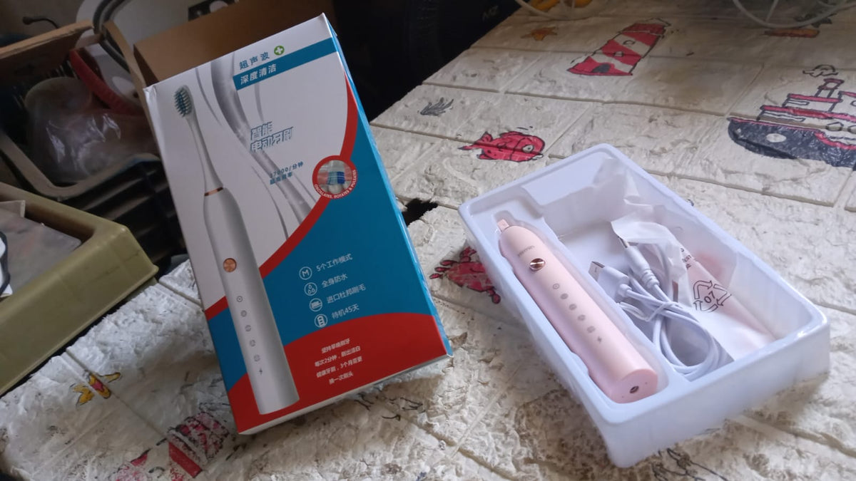 Detailed view of the Electric Toothbrush head, showing bristles and tongue cleaner.