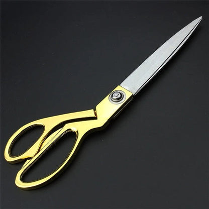 Sharp stainless steel tailoring scissors with golden handle.