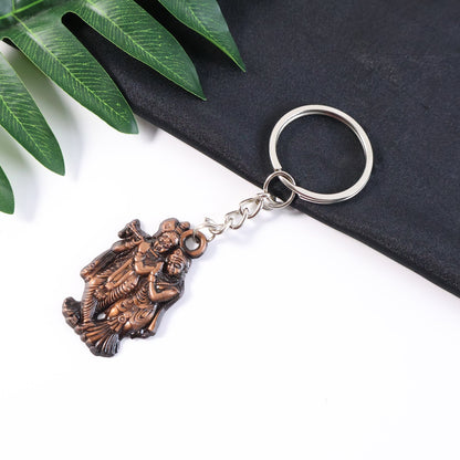 Radha Krishna metal keychain attached to a set of keys symbolizing faith and function