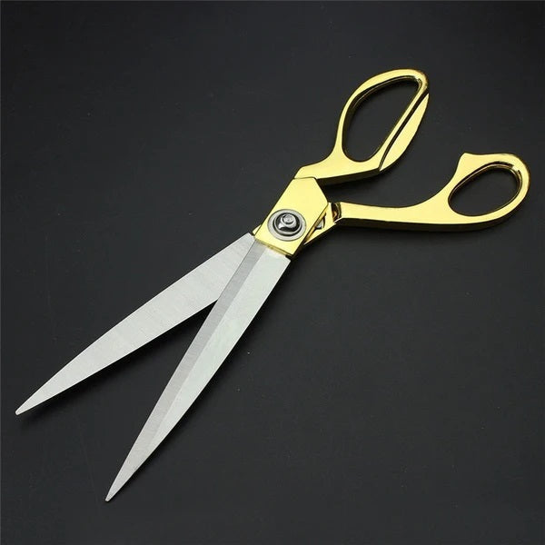 Golden handle cloth cutting scissors with sharp blades.