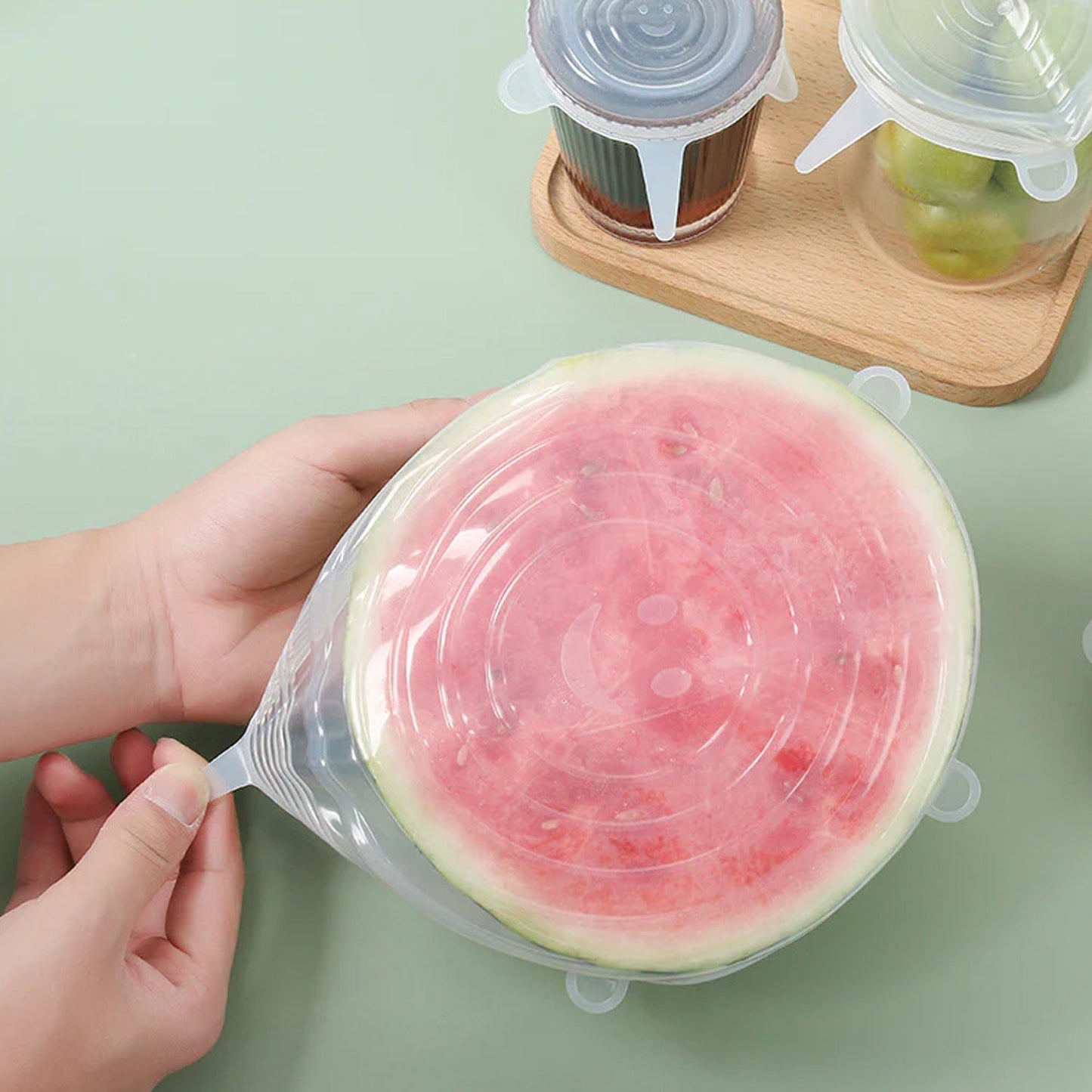 Reusable silicone food covers being used on kitchen containers