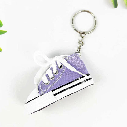 Miniature high-top basketball shoe keychain with black laces.
