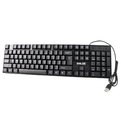 Person typing comfortably on the Wired USB Keyboard at a home office desk setup.