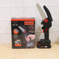 Person using mini cordless electric chainsaw to cut a tree branch