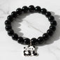 Black beaded stretch bracelet with an adorable panda charm on white background.