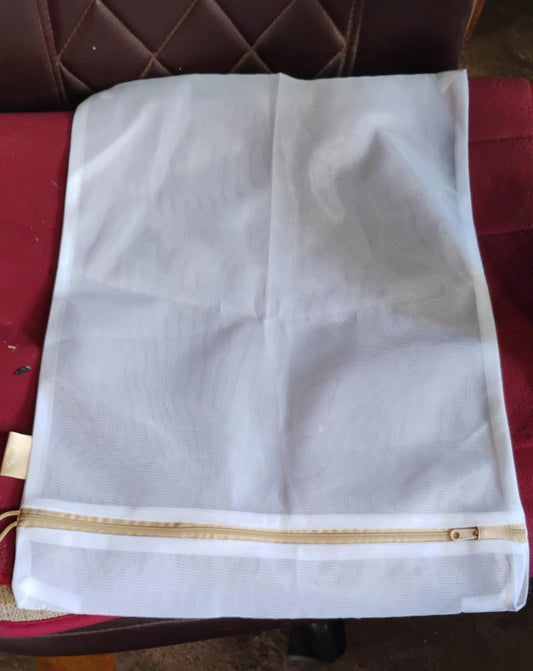 Keeping laundry organised and protecting clothes with a mesh delicates bag.
